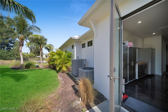 2405 SW 11th Ave, Cape Coral, FL 33991 - view of grassy yard featuring central air condition unit