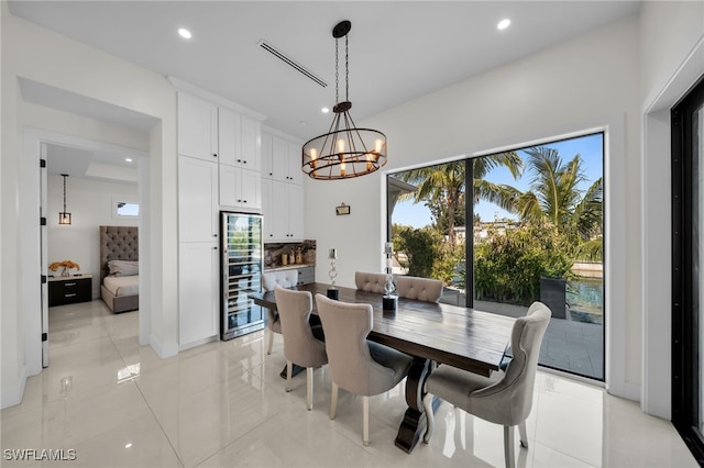 2405 SW 11th Ave, Cape Coral, FL 33991 - dining room featuring wine cooler, a chandelier, recessed lighting, baseboards, and light tile patterned floors