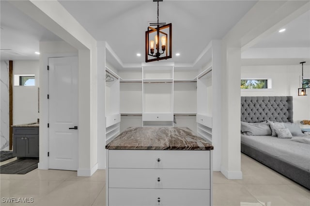 2405 SW 11th Ave, Cape Coral, FL 33991 - spacious closet with light tile patterned floors and a chandelier