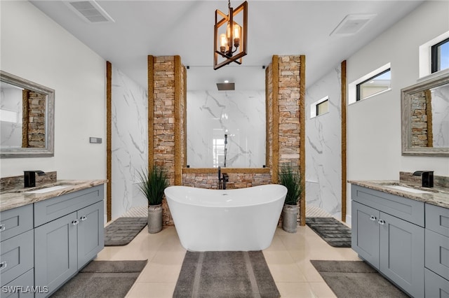 2405 SW 11th Ave, Cape Coral, FL 33991 - full bathroom with a marble finish shower, a freestanding tub, two vanities, and a chandelier