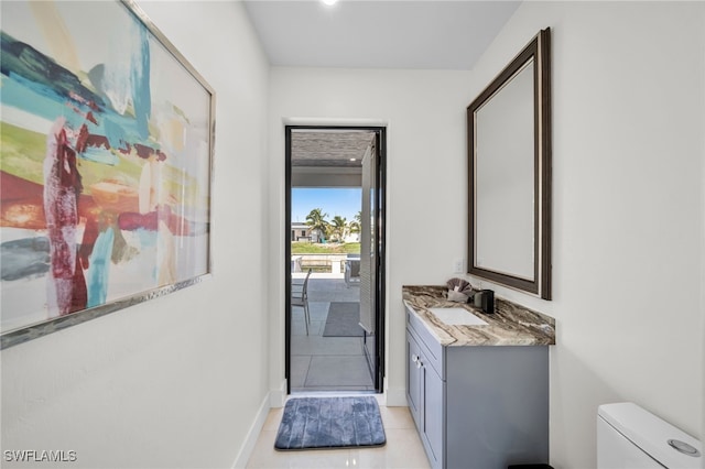 2405 SW 11th Ave, Cape Coral, FL 33991 - bathroom with vanity, toilet, tile patterned flooring, and baseboards