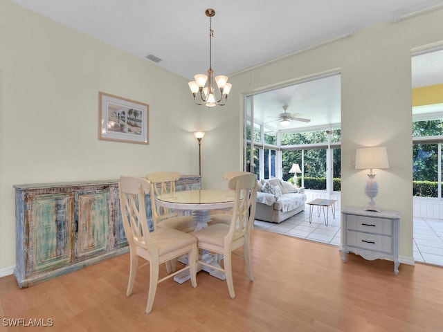 2040 Embarcadero Way N, Fort Myers, FL 33917 - dining area featuring wood finished floors, a chandelier, a ceiling fan, and baseboards