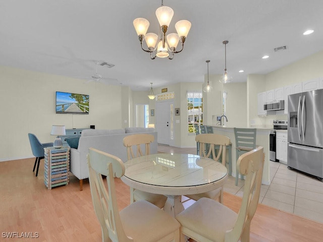 2040 Embarcadero Way N, Fort Myers, FL 33917 - dining room featuring a chandelier, light wood-style flooring, baseboards, ceiling fan, and recessed lighting