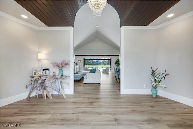 4701 Oak Leaf Dr, Naples, FL 34119 - entryway featuring vaulted ceiling, a chandelier, ornamental molding, baseboards, and wood finished floors