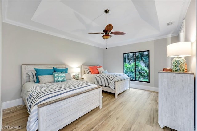 4701 Oak Leaf Dr, Naples, FL 34119 - bedroom featuring a raised ceiling, light wood-type flooring, baseboards, ornamental molding, and a ceiling fan