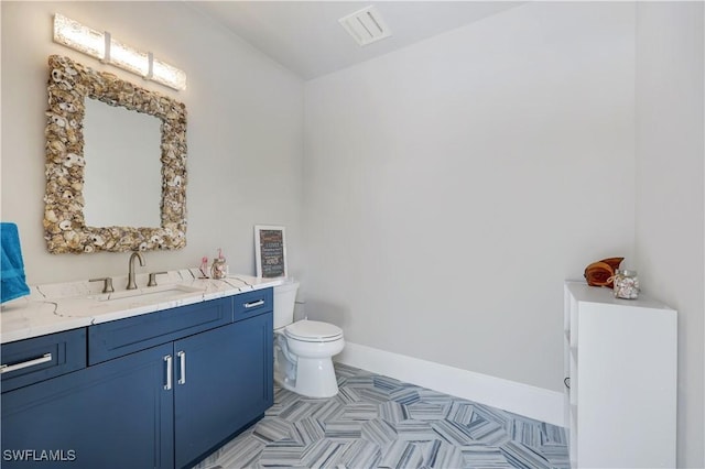 4701 Oak Leaf Dr, Naples, FL 34119 - bathroom featuring toilet, vanity, and baseboards