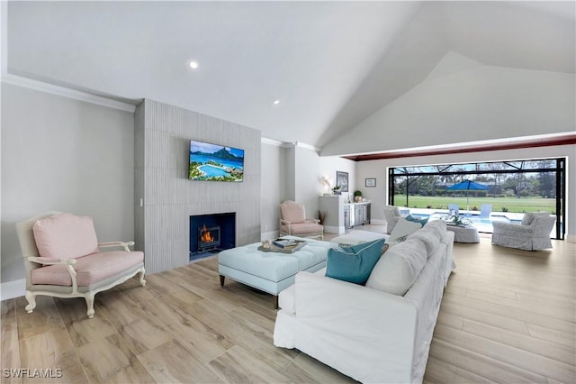 4701 Oak Leaf Dr, Naples, FL 34119 - living area featuring a fireplace, high vaulted ceiling, wood finished floors, and recessed lighting