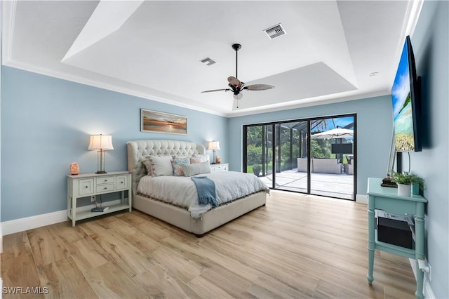 4701 Oak Leaf Dr, Naples, FL 34119 - bedroom with a raised ceiling, access to exterior, light wood-style floors, and baseboards