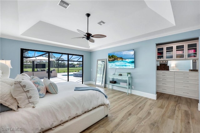 4701 Oak Leaf Dr, Naples, FL 34119 - bedroom featuring a tray ceiling, access to outside, baseboards, and light wood-style floors
