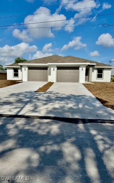 326/328 Limerick Ave S, Lehigh Acres, FL 33974 - view of front of property with a garage, concrete driveway, and stucco siding