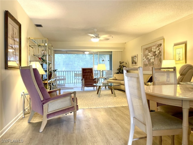 325 Charlemagne Blvd Unit B207, Naples, FL 34112 - living area featuring wood finished floors, ceiling fan, and baseboards