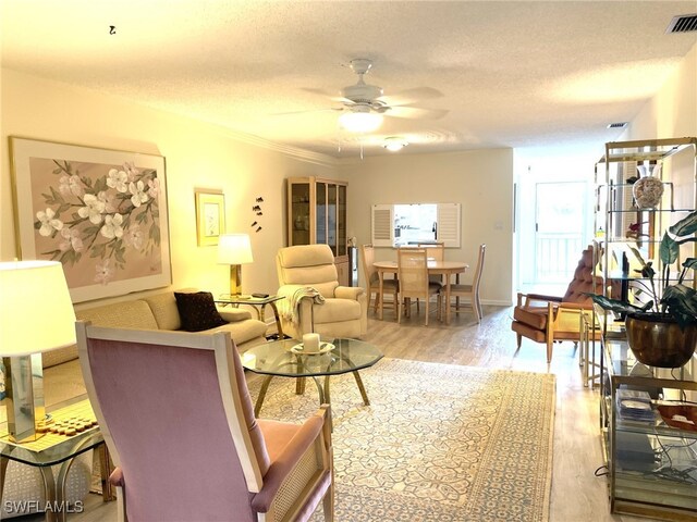 325 Charlemagne Blvd Unit B207, Naples, FL 34112 - living room with ceiling fan, a textured ceiling, and light wood-style flooring