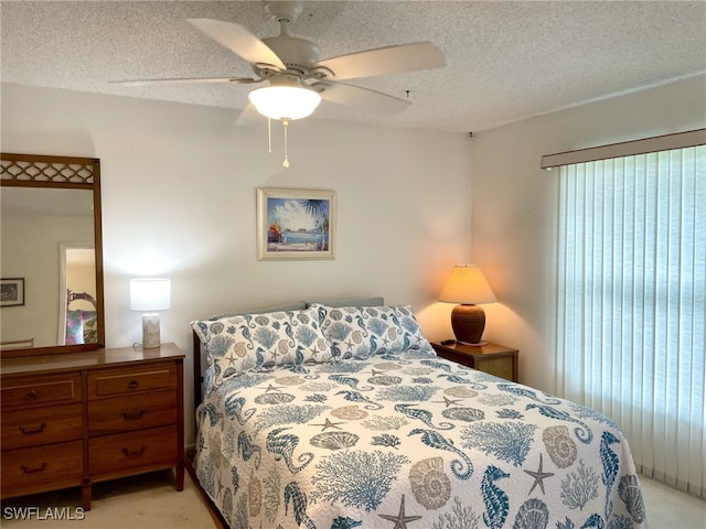 325 Charlemagne Blvd Unit B207, Naples, FL 34112 - bedroom featuring light colored carpet, a textured ceiling, and ceiling fan