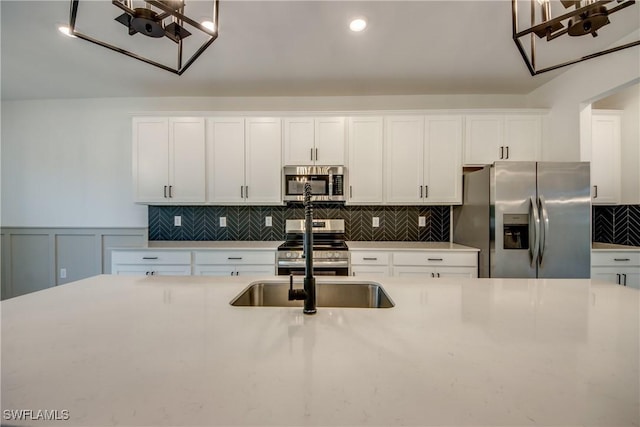 11260 Canopy Loop, Fort Myers, FL 33913 - kitchen featuring stainless steel appliances, light countertops, white cabinets, tasteful backsplash, and a sink