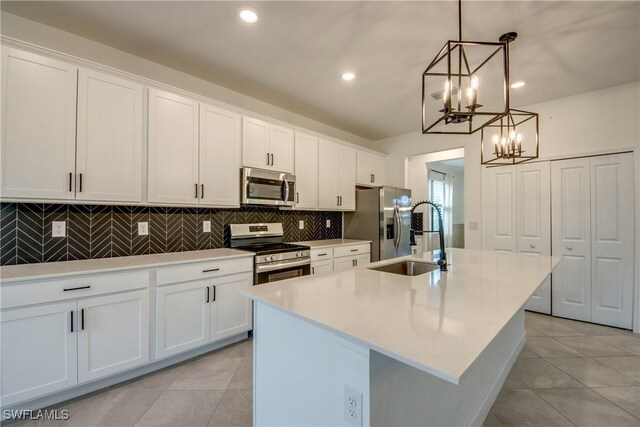 11260 Canopy Loop, Fort Myers, FL 33913 - kitchen with appliances with stainless steel finishes, a sink, a chandelier, light tile patterned flooring, and recessed lighting