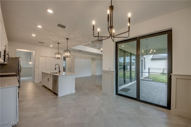 11260 Canopy Loop, Fort Myers, FL 33913 - kitchen featuring a chandelier, light countertops, stainless steel appliances, white cabinetry, and a sink