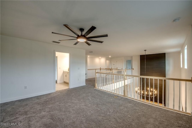 11260 Canopy Loop, Fort Myers, FL 33913 - spare room featuring baseboards, carpet floors, a ceiling fan, and a chandelier
