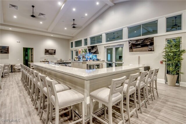 11260 Canopy Loop, Fort Myers, FL 33913 - community bar area featuring beam ceiling, high vaulted ceiling, ceiling fan, light wood-style flooring, and recessed lighting