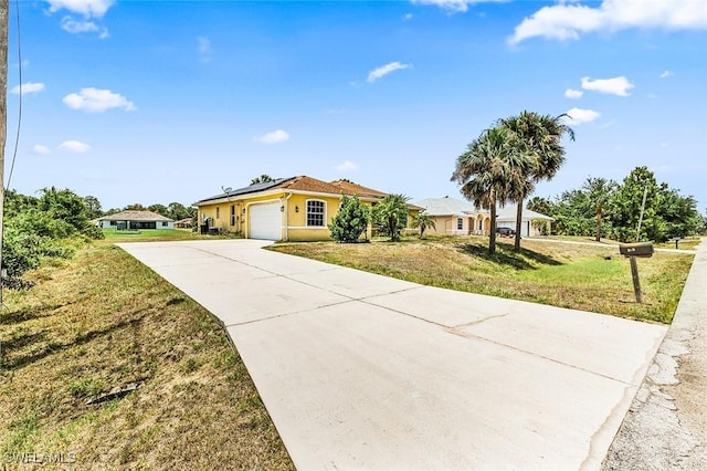 707 8th Ave, Lehigh Acres, FL 33972 - single story home with solar panels, driveway, an attached garage, a front lawn, and stucco siding
