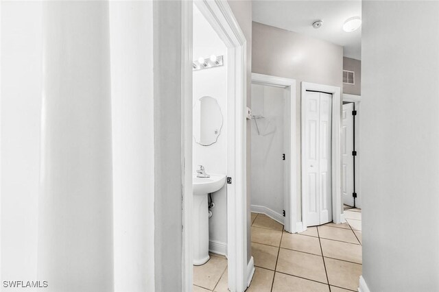 707 8th Ave, Lehigh Acres, FL 33972 - bathroom with a closet, tile patterned flooring, and baseboards