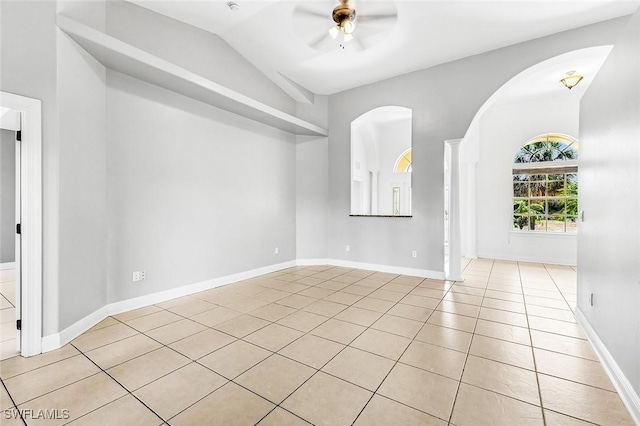 707 8th Ave, Lehigh Acres, FL 33972 - spare room with ceiling fan, light tile patterned floors, vaulted ceiling, and arched walkways