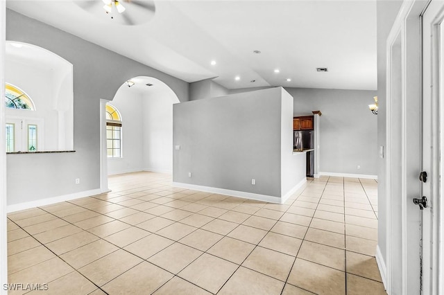 707 8th Ave, Lehigh Acres, FL 33972 - spare room featuring a ceiling fan, light tile patterned floors, lofted ceiling, recessed lighting, and arched walkways