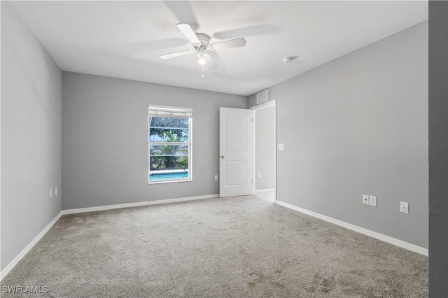 2903 NW 5th Pl, Cape Coral, FL 33993 - empty room featuring carpet floors, a ceiling fan, and baseboards