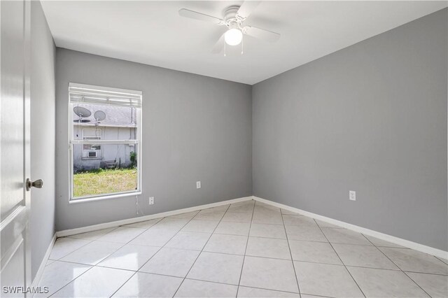 2903 NW 5th Pl, Cape Coral, FL 33993 - spare room featuring plenty of natural light, a ceiling fan, light tile patterned flooring, and baseboards