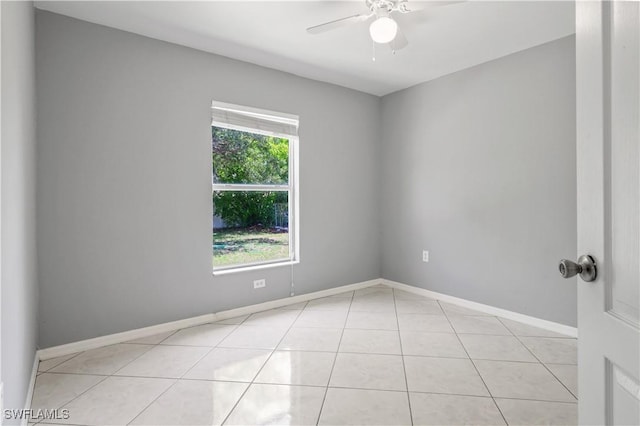 2903 NW 5th Pl, Cape Coral, FL 33993 - empty room with a ceiling fan, light tile patterned floors, and baseboards