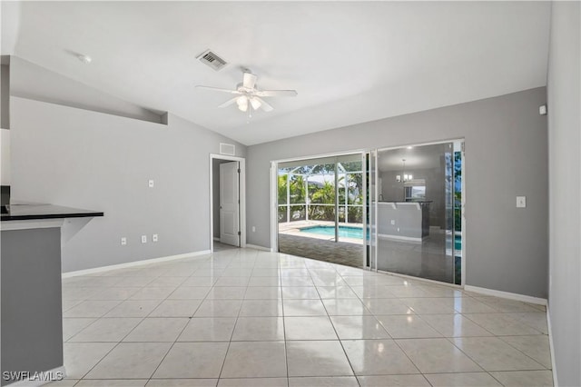 2903 NW 5th Pl, Cape Coral, FL 33993 - tiled empty room with lofted ceiling, a ceiling fan, and baseboards