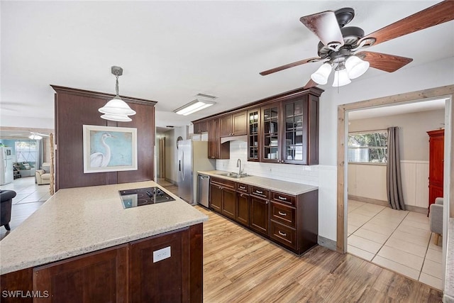 736 94th Ave N, Naples, FL 34108 - kitchen with appliances with stainless steel finishes, a sink, a ceiling fan, dark brown cabinetry, and a wainscoted wall
