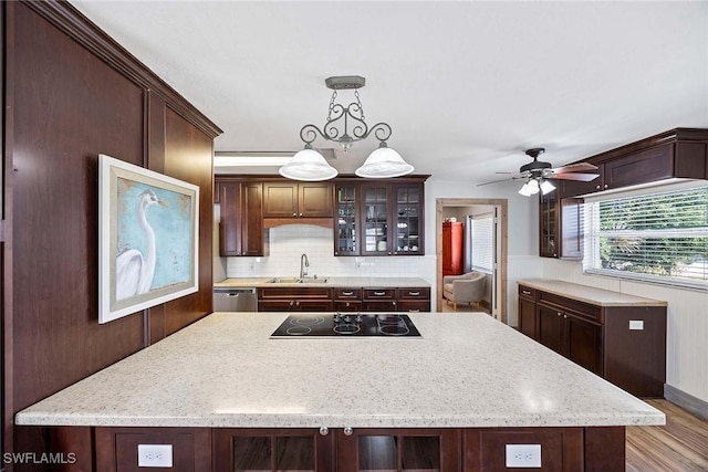 736 94th Ave N, Naples, FL 34108 - kitchen featuring black electric stovetop, a sink, glass insert cabinets, tasteful backsplash, and ceiling fan