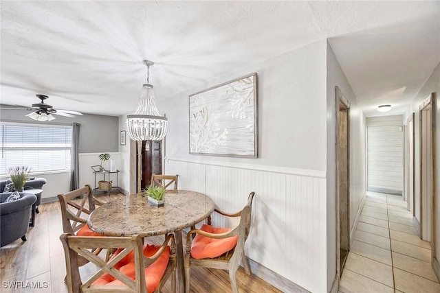 736 94th Ave N, Naples, FL 34108 - dining area with a wainscoted wall, a chandelier, and ceiling fan