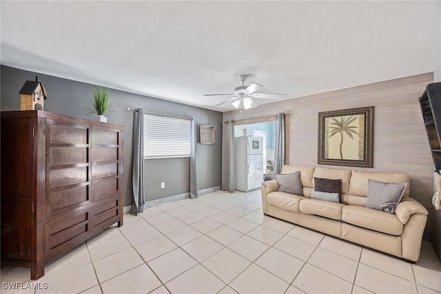 736 94th Ave N, Naples, FL 34108 - living room with ceiling fan, light tile patterned floors, baseboards, and wood walls