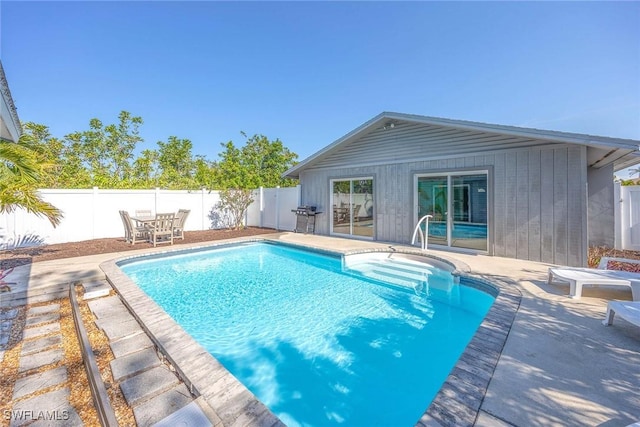 668 94th Ave N, Naples, FL 34108 - view of swimming pool with a patio, a fenced backyard, area for grilling, and outdoor dining area