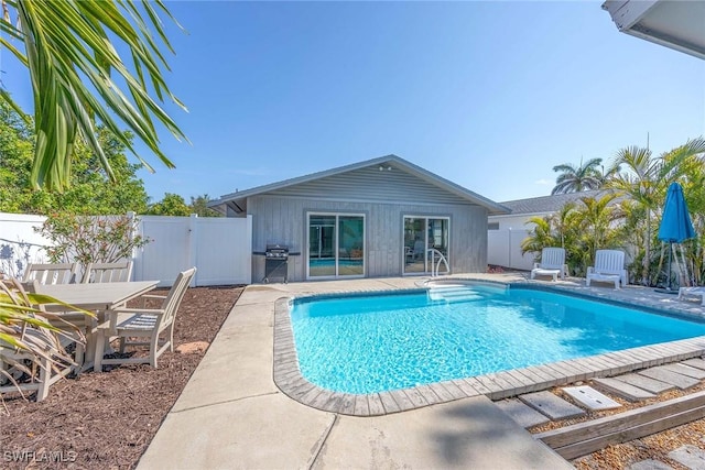 668 94th Ave N, Naples, FL 34108 - view of pool featuring a patio, a fenced backyard, and area for grilling