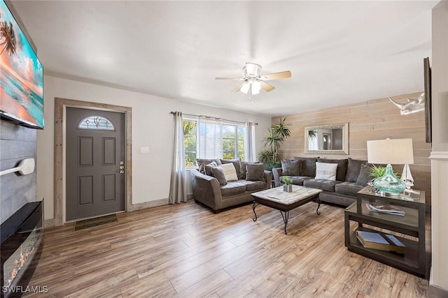 668 94th Ave N, Naples, FL 34108 - living area with ceiling fan, light wood-style flooring, and a glass covered fireplace