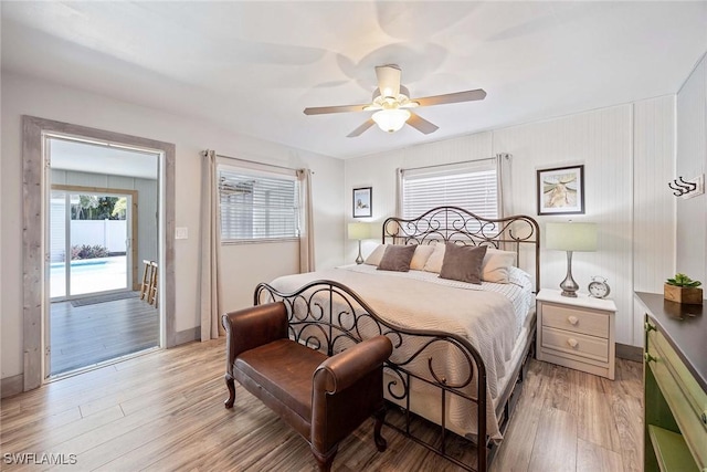 668 94th Ave N, Naples, FL 34108 - bedroom featuring light wood-type flooring, access to exterior, a ceiling fan, and baseboards
