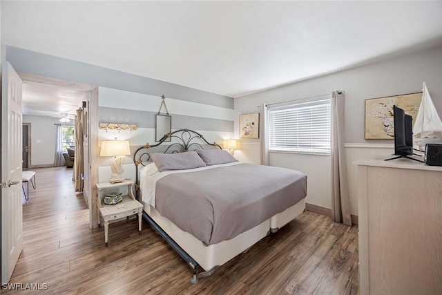668 94th Ave N, Naples, FL 34108 - bedroom with wood finished floors and a wainscoted wall