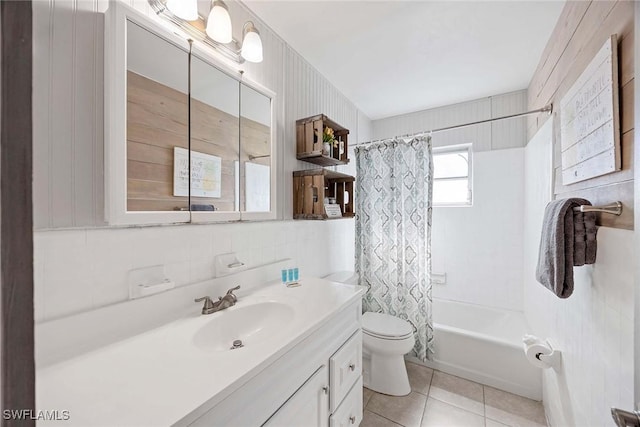 668 94th Ave N, Naples, FL 34108 - full bathroom featuring vanity, toilet, tile patterned flooring, shower / bath combo, and tile walls