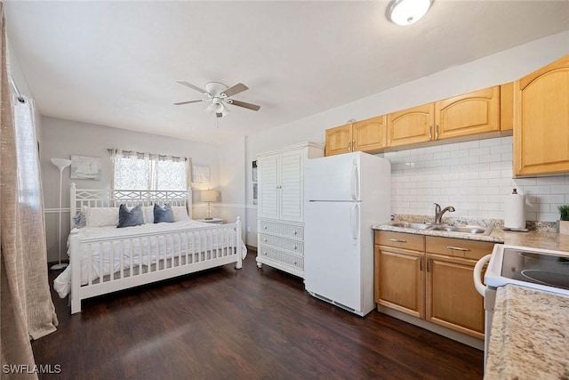 668 94th Ave N, Naples, FL 34108 - bedroom with freestanding refrigerator, a sink, dark wood finished floors, and a ceiling fan