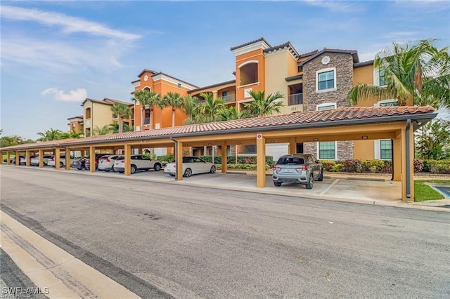 9731 Acqua Ct Unit 537, Naples, FL 34113 - view of building exterior featuring covered parking