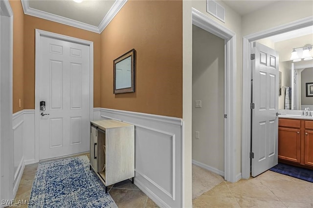 9731 Acqua Ct Unit 537, Naples, FL 34113 - entryway with ornamental molding, wainscoting, and light tile patterned floors