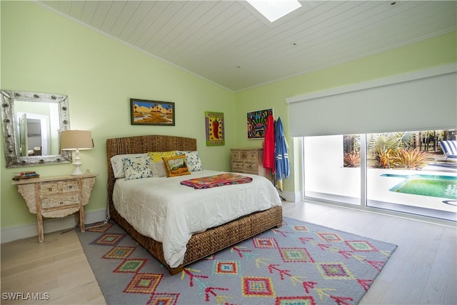 5880 Shady Oaks Ln, Naples, FL 34119 - bedroom with lofted ceiling, wood finished floors, access to exterior, crown molding, and a skylight