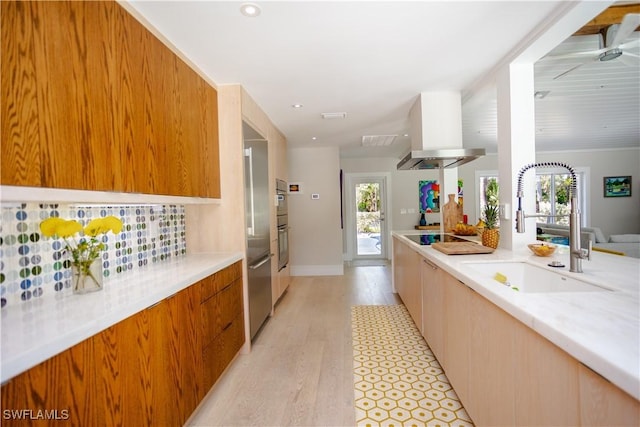 5880 Shady Oaks Ln, Naples, FL 34119 - kitchen with modern cabinets, a sink, island range hood, light countertops, and light wood-type flooring