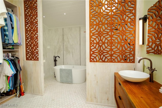 5880 Shady Oaks Ln, Naples, FL 34119 - bathroom featuring a soaking tub, vanity, and tile patterned floors