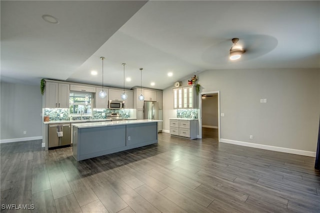 14160 Cedardale St, Fort Myers, FL 33905 - kitchen featuring appliances with stainless steel finishes, ceiling fan, tasteful backsplash, a kitchen island, and lofted ceiling