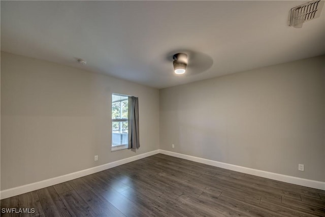 14160 Cedardale St, Fort Myers, FL 33905 - spare room with baseboards, dark wood-type flooring, and a smoke detector