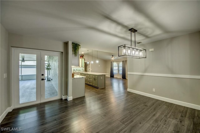 14160 Cedardale St, Fort Myers, FL 33905 - unfurnished living room featuring dark wood-style flooring, french doors, baseboards, and a chandelier