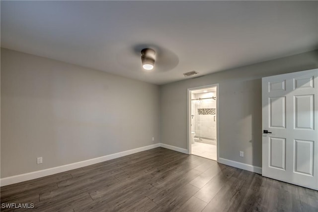 14160 Cedardale St, Fort Myers, FL 33905 - unfurnished bedroom featuring baseboards, dark wood-style flooring, ensuite bathroom, and a ceiling fan